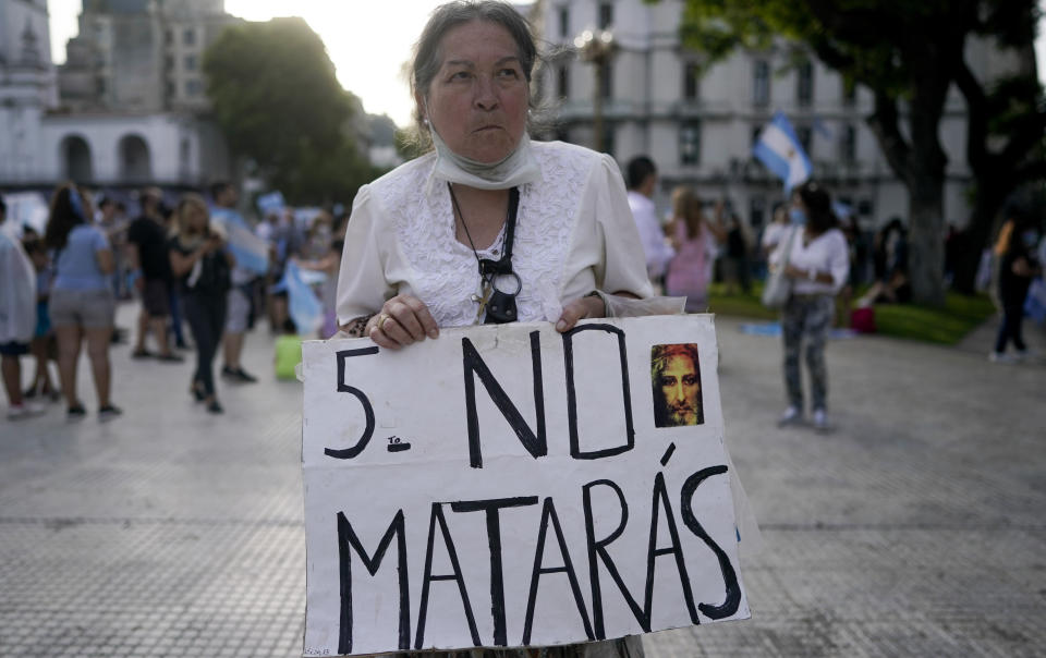 An activist against abortion holds a sign that reads in Spanish "Thou Shalt not kill" as she protests against the decriminalization of abortion, one day before lawmakers will debate its legalization, at Plaza de Mayo in Buenos Aires, Argentina, Monday, Dec. 28, 2020. (AP Photo/Victor R. Caivano)