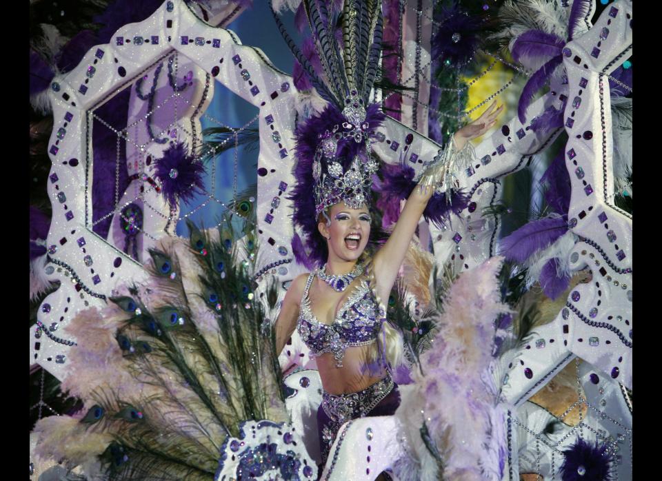 A nomine for Queen of the Santa Cruz carnival shows off her outfit under the watchful eyes of the jury at Santa Cruz de Tenerife on the Spanish Canary island of Tenerife, February 15, 2012. (DESIREE MARTIN/AFP/Getty Images)