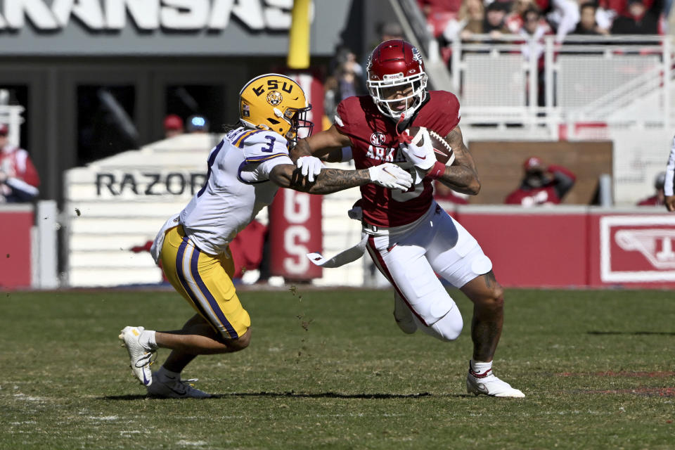 Arkansas wide receiver Jadon Haselwood (9) tries to shake LSU safety Greg Brooks Jr. (3) during the game Saturday, Nov. 12, 2022, in Fayetteville, Ark. (AP Photo/Michael Woods)