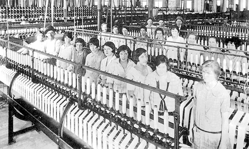 Workers at the Loray Mill by spinners in this Gazette file photograph.