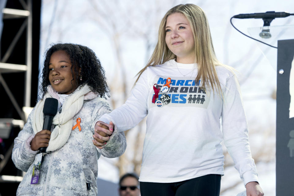 FILE - Jaclyn Corin, a student activist from Marjory Stoneman Douglas High School in Parkland, Fla. holds hands with Yolanda Renee King, granddaughter of Martin Luther King Jr., at the "March for Our Lives" rally in support of gun control in Washington, Saturday, March 24, 2018. Corin, a 21-year-old Harvard junior as the Parkland shooter appeared in court in Oct. 2021, purposely stayed off social media the week of the court proceedings, knowing it would be too troubling, saying "the shooting continues to effect my day to day life in ways I never could have imagined." (AP Photo/Andrew Harnik, File)