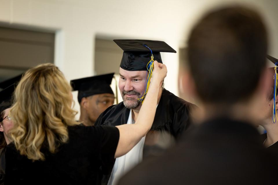 Kevin Peterson gets some help adjusting his tassel at the end of a commencement ceremony for incarcerated individuals earning their high school diploma at the Utah State Correctional Facility on June 5, 2023.