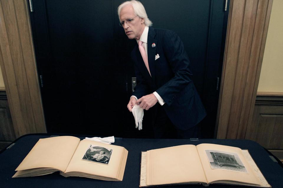 Robert M. Edsel, founder and president of Monuments Men Foundation for the Preservation of Art starts to show two newly discovered albums containing photographs of art works and furniture stolen by the Nazis during World War II after they were unveiled at a news conference in the Meadows Museum at SMU in Dallas, Tuesday, Feb. 27, 2012. The Dallas-based Monuments Men Foundation for the Preservation of Art had been contacted by relatives of two World War II soldiers who took the albums from Hitler's home. They'll be donated to the U.S. National Archives. (AP Photo/LM Otero)