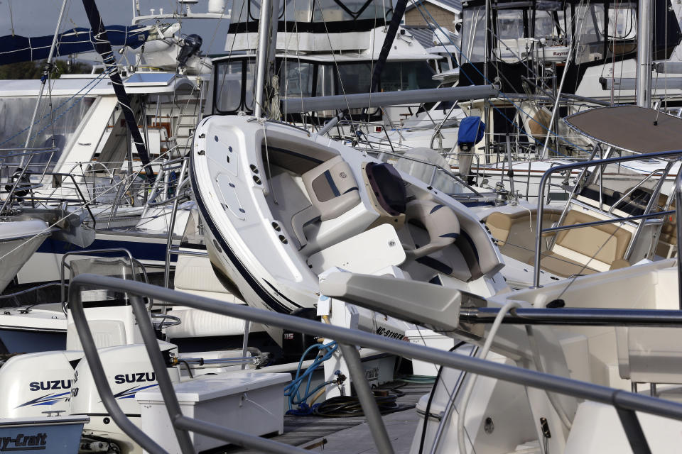 Boats are piled on each other at the Southport Marina following the effects of Hurricane Isaias in Southport, N.C., Tuesday, Aug. 4, 2020. (AP Photo/Gerry Broome)