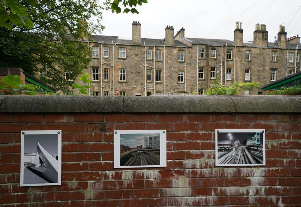Photographs attached to a wall as part of the exhibition (Andrew Milligan/PA) (PA Wire)