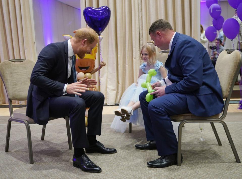 Prince Harry with Poppy and her father Daniel Higham at the WellChild Awards (Yui Mok/PA Wire)