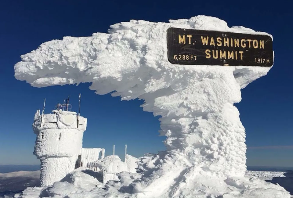 Five feet of rime ice on the summit sign at the Mount Washington Observatory.