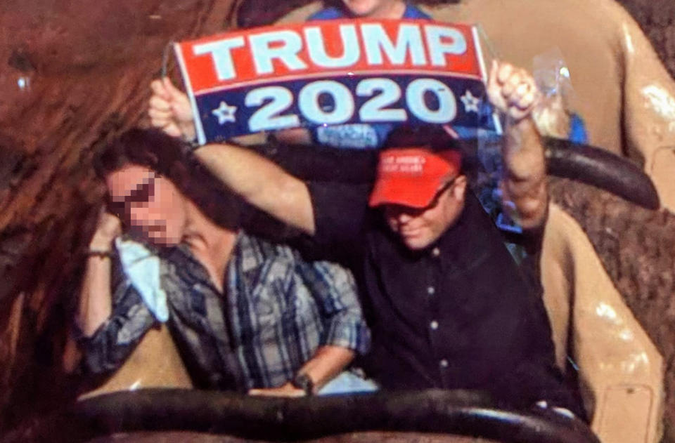 Dion Cini holds a Trump 2020 banner at Walt Disney World. The image was blurred by the source. (Courtesy Dion Cini)