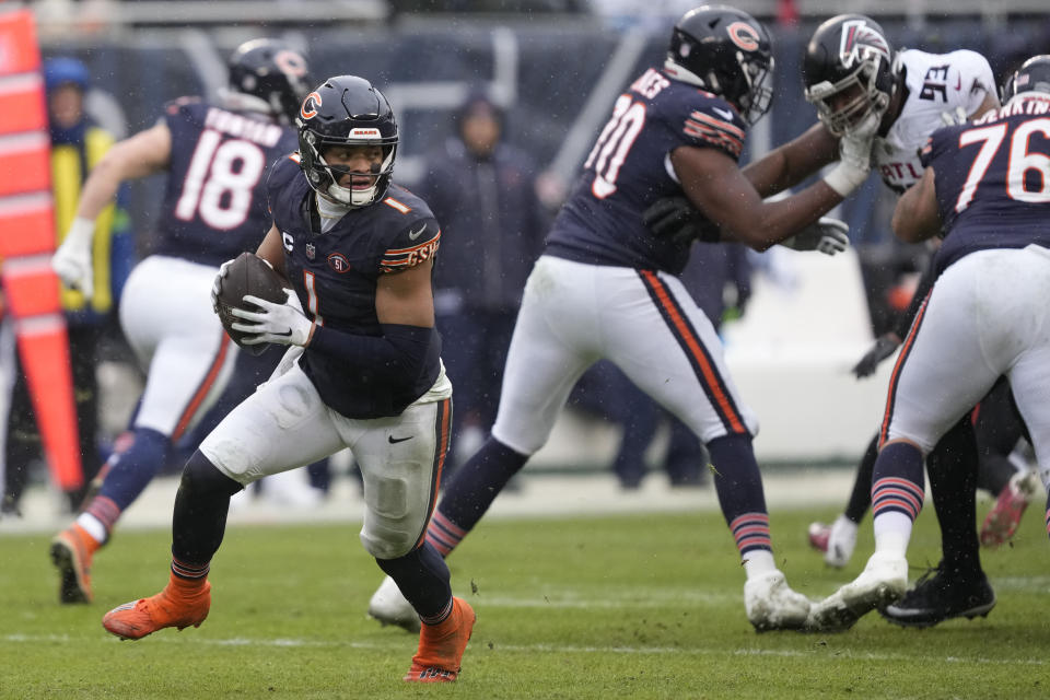 Chicago Bears quarterback Justin Fields (1) runs the ball in the first half of an NFL football game against the Atlanta Falcons in Chicago, Sunday, Dec. 31, 2023. (AP Photo/Charles Rex Arbogast)