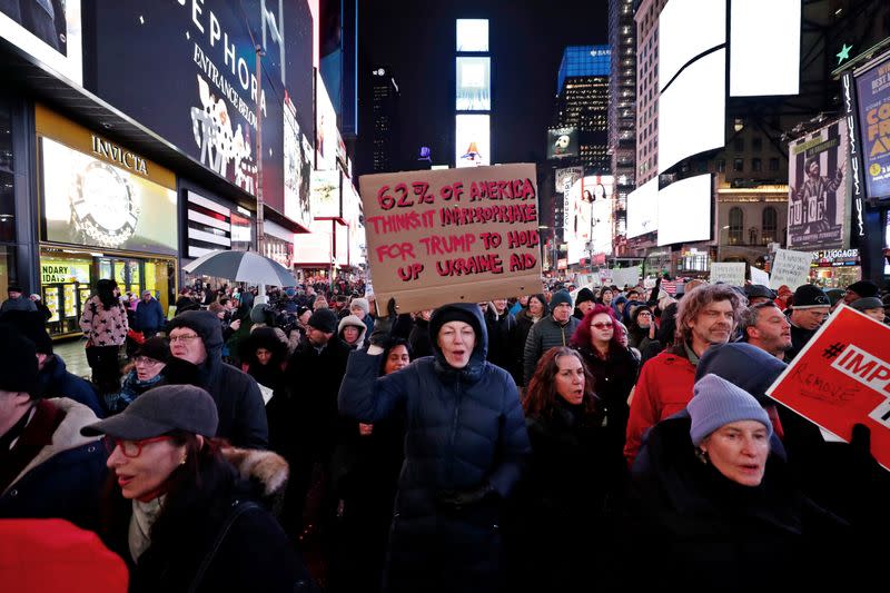 Demonstrators gather to demand the impeachment and removal of U.S. President Donald Trump during a rally at Times Square in New York City