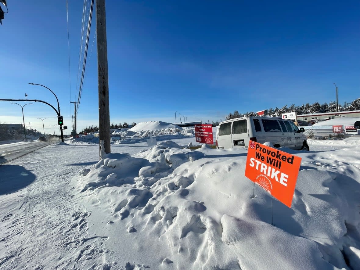 Strike signs stands near the entrance to a city-managed construction site in Yellowknife. Lawyers for the city and the union will once again return to court to argue the merits of a court-ordered injunction against picket line activity. (Walter Strong/CBC - image credit)