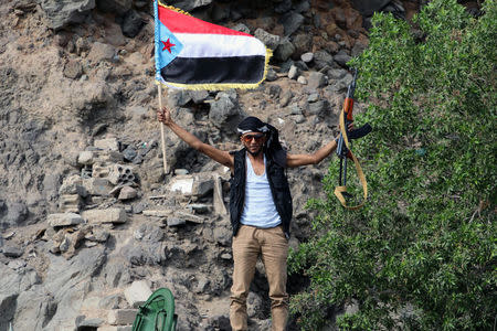 FILE PHOTO: A southern Yemeni separatist waves the flag of former South Yemen as he stands on a tank in the port city of Aden, Yemen January 30, 2018. REUTERS/Fawaz Salman/File Photo