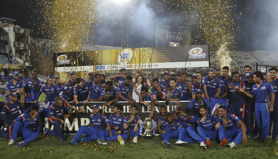 Members of Mumbai Indians team and team owner Nita Ambani, center, pose with the trophy after their win over Chennai Super Kings in the final cricket match of VIVO IPL T20 in Hyderabad, India, early Monday, May 13, 2019. Mumbai Indians won the match by one run. (AP Photo/ Mahesh Kumar A.)