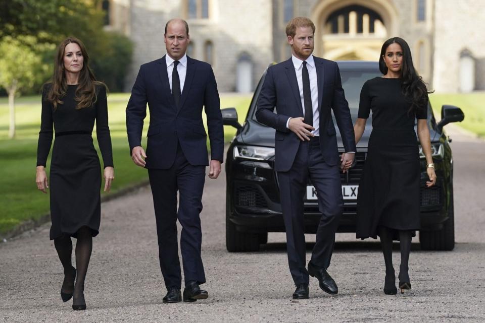 Mandatory Credit: Photo by Kirsty O'Connor/AP/Shutterstock (13381259a) From left, Kate, the Princess of Wales, Prince William, Prince of Wales, Prince Harry and Meghan, Duchess of Sussex walk to meet members of the public at Windsor Castle, following the death of Queen Elizabeth II on Thursday, in Windsor, England Royals, Windsor, United Kingdom - 10 Sep 2022