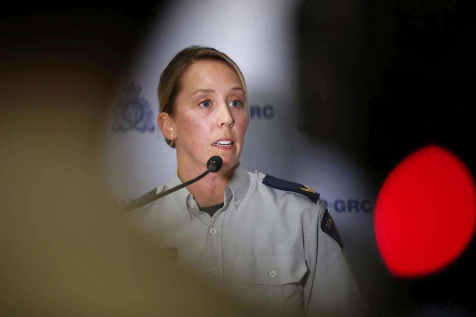 Royal Canadian Mounted Police Cpl. Julie Courchaine speaks to media about the ongoing RCMP search in Gillam, Manitoba, for the British Columbia murder suspects Bryer Schmegelsky and Kam McLeod, in Winnipeg, Manitoba, Friday, July 26, 2019. Canadian police will conduct a door-to-door canvas in two communities in Manitoba over the next three days while pressing the search for two suspects in the slaying of an American woman, her Australian boyfriend and another man. (John Woods/The Canadian Press via AP)