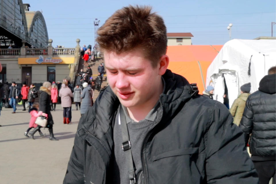 Vladyslav Hrudiy, 17, reacts after his grandmother collapsed upon their arrival in Lviv.  (Paul Rigney / NBC News)