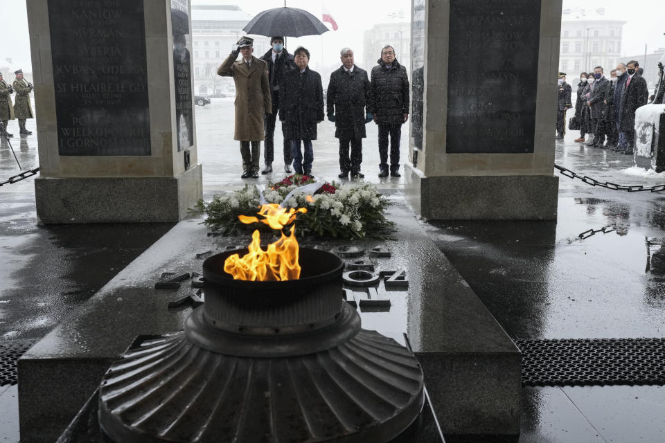 Japan's Foreign Minister Yoshimasa Hayashi, center left, attends a wreath-laying ceremony at the Tomb to the Unknown Soldier in Warsaw, Poland, Saturday, April 2, 2022. During his visit Hayashi will meet with international humanitarian organisations and refugees who have fled Russia's invasion of Ukraine. (AP Photo/Czarek Sokolowski)