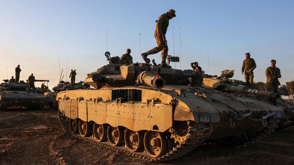 PHOTO: Israeli soldiers stand on tanks deployed on the southern border with the Gaza Strip, Nov. 29, 2023. (Menahem Kahana/AFP via Getty Images)