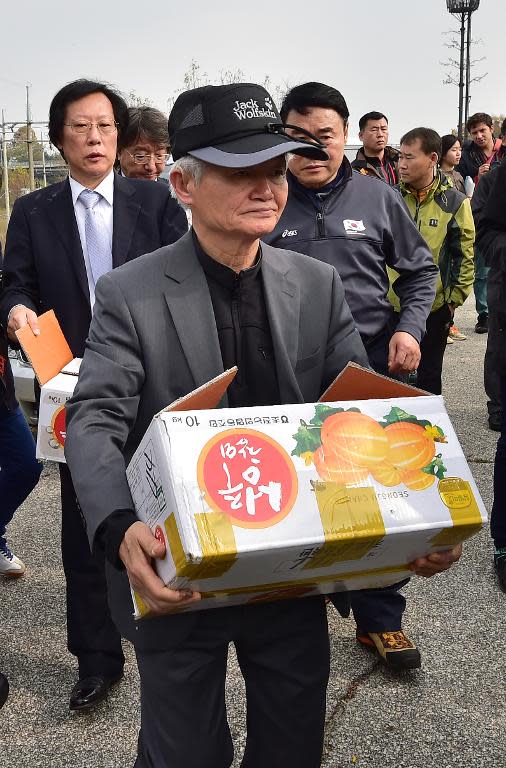 South Korean activists carry boxes containing anti-North Korea leaflets after they were blocked by local residents near Imjingak peace park in the border city of Paju, on October 25, 2014