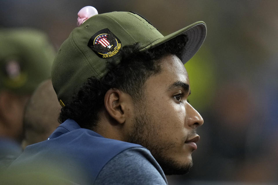 Tampa Bay Rays rookie pitcher Taj Bradley has bubble from gum on his hat as he watches against the Milwaukee Brewers during the eighth inning of a baseball game Saturday, May 20, 2023, in St. Petersburg, Fla. (AP Photo/Chris O'Meara)