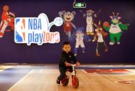 A boy plays outside the NBA Playzone at a shopping mall in Beijing