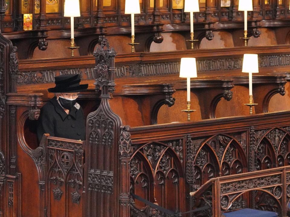 Queen Elizabeth II takes her seat during the funeral of Prince Philip, Duke of Edinburgh, at St George's Chapel at Windsor Castle on April 17, 2021 in Windsor, England