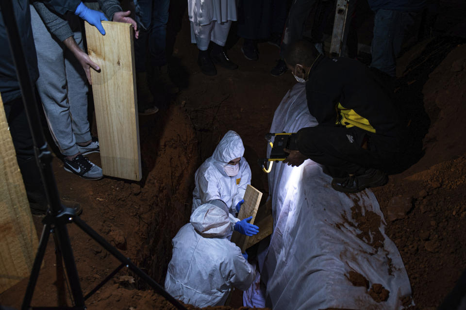 FILE — In this Sunday, June 27, 2021 file photo a Muslim burial of a COVID-19 victim takes place at the Westpark Cemetery in Johannesburg. Driven by the delta variant, a new wave of COVID-19 is sweeping across the African continent where new cases, hospital admissions, and deaths are increasing. (AP Photo/Ali Greeff)