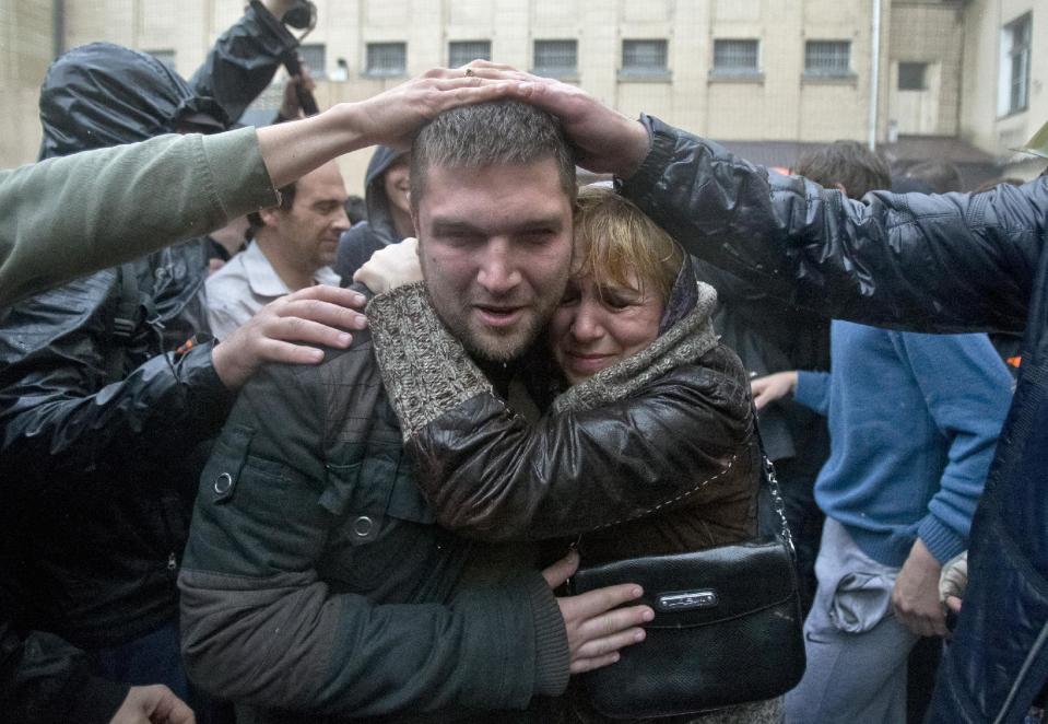 A man is greeted by supporters after being released from a local police station which was stormed by pro-Russian protesters in Odessa, Ukraine, Sunday, May 4, 2014. Several prisoners that were detained during clashes that erupted Friday between pro-Russians and government supporters in the key port on the Black Sea coast were released under the pressure of protesters that broke into a local police station and received a hero's welcome by crowds. (AP Photo/Vadim Ghirda)