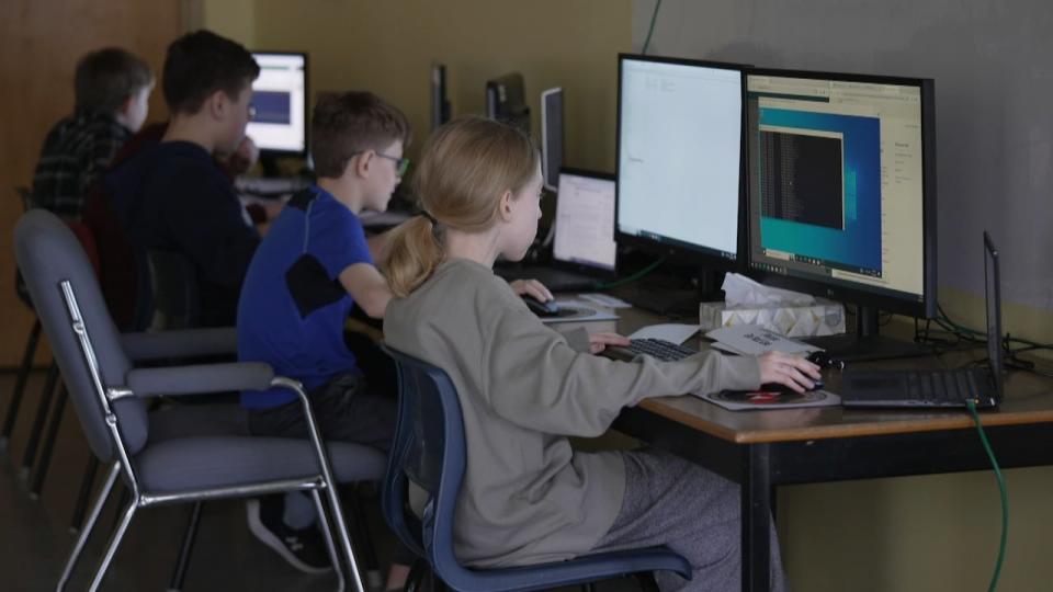 The Firewall Fighters, a group of five Grade 6 students, work out of an empty classroom where they spend hours upon hours researching and preparing for the upcoming national competition. 