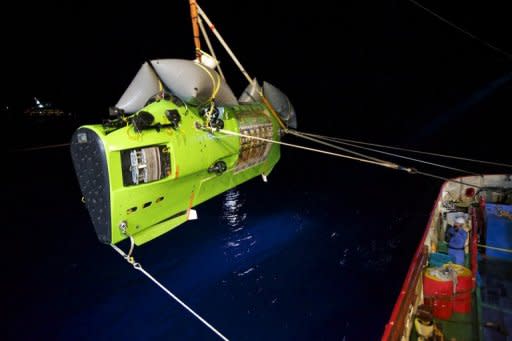 The Deepsea Challenger submersible carrying filmmaker and National Geographic Explorer-in-Residence James Cameron is hoisted into the Pacific Ocean on Monday on its way to the âChallenger Deep,â the deepest part of the Mariana Trench. Cameron described a barren "completely alien world" on the ocean floor