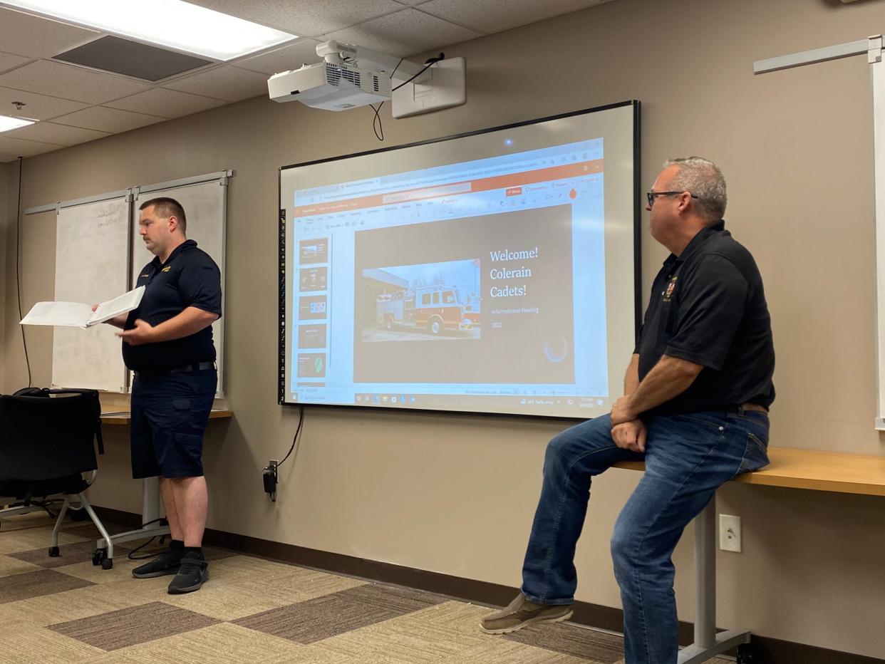 Firefighter and paramedic AJ Coley (left) and Battalion Chief Steven Conn (right) tell interested high schoolers about Colerain Township's new fire cadet program. The program will serve as an exploration of the firefighting career in which students will get classroom and hands-on learning.