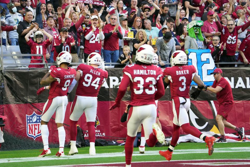 Jan 9, 2022; Glendale, Arizona, USA; Arizona Cardinals defensive end Zach Allen (94) returns a fumble for a touchdown against the Seattle Seahawks during the first half at State Farm Stadium.