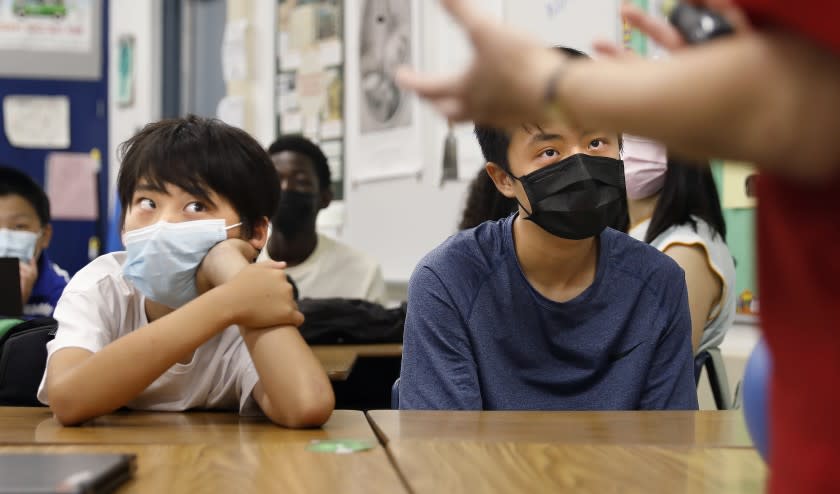 ARCADIA-CA-SEPTEMER 10, 2021: Lucas Sun, left, and Vito Hsu, both 13, listen as their teacher Karalee Nakatsuka instructs a history lesson about 9/11 at First Avenue Middle School in Arcadia on Friday, September 10, 2021. (Christina House / Los Angeles Times)