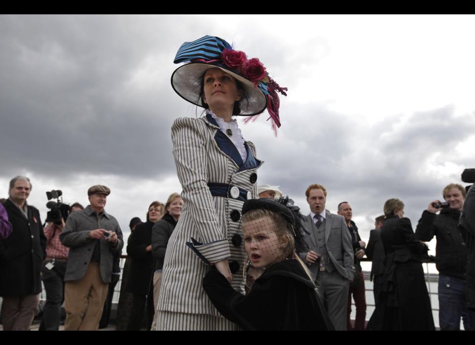 Wearing period costumes, Bpassenger Jacki Free holds her daughter, name not given, as the MS Balmoral Titanic memorial cruise ship sails from Southampton, England. 