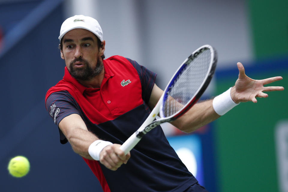 Jeremy Chardy of France hits a return shot against Alexander Zverev of Germany during the men's singles match at the Shanghai Masters tennis tournament at Qizhong Forest Sports City Tennis Center in Shanghai, China, Wednesday, Oct. 9, 2019. (AP Photo/Andy Wong)