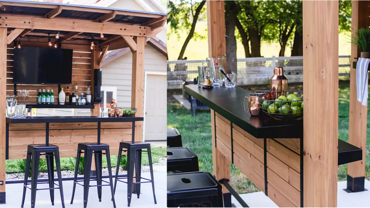 a bar with stools and a table with a drink on it