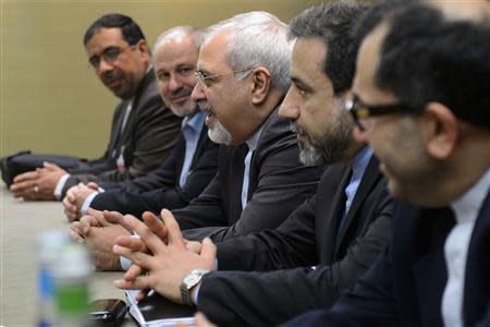 Iranian Foreign Minister Mohammad Javad Zarif (C), flanked by members of his delegation, attends talks over Iran's nuclear programme in Geneva November 22, 2013. REUTERS/Fabrice Coffrini/Pool