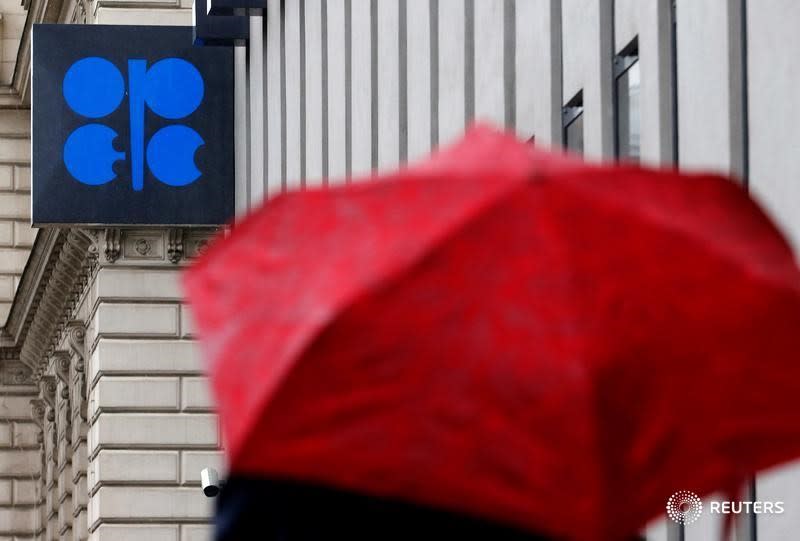 A person carrying an umbrella walks by the Ogranization of the Petroleum Exporting Countries (OPEC) headquarters in Vienna, Austria October 4, 2016. REUTERS/Heinz-Peter Bader