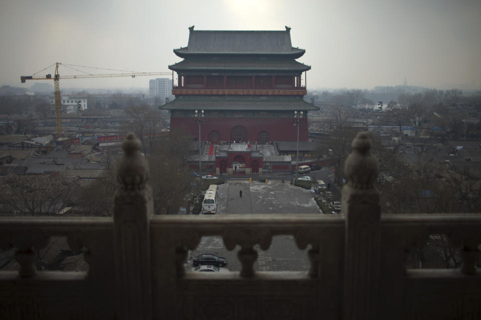 In this Jan. 15, 2013 photo, seen from the Bell Tower, a crane works on a construction site near the Drum Tower among "hutong" courtyard homes in central Beijing, China. The district government wants to demolish these dwellings, move their occupants to bigger apartments farther from the city center and redevelop a square in 18th century Qing Dynasty fashion. (AP Photo/Alexander F. Yuan)