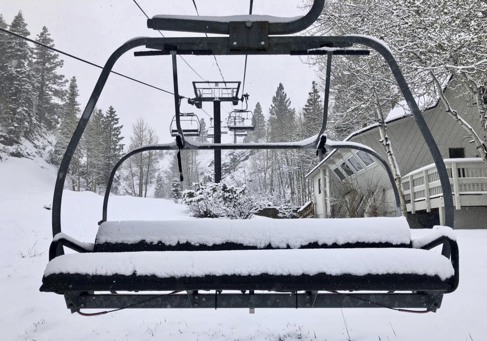 In this Tuesday, May 21, 2019, photo provided by Squaw Valley Alpine Meadows, is a snow covered chair lift at the Squaw Valley Ski Resort in Olympic Valley, Calif. Memorial Day may be the unofficial start of summer, but California is heading toward the holiday with rainy, windy and snowy weather. The Squaw Valley resort at Lake Tahoe reports it got 32 inches of snow over the past seven days, boosting its season total to 714 inches. Unsettled weather will continue into next week. (Ben Arnst/Squaw Valley Alpine Meadows via AP)