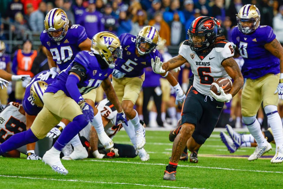 Oregon State Beavers running back Damien Martinez (6) rushes against the Washington Huskies during the first quarter at Alaska Airlines Field at Husky Stadium on Nov. 4, 2022, in Seattle.