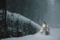 In this photo provided by the Mammoth Mountain Ski Area, a snowplow clears fresh snow around the Mammoth Mountain ski resort in Mammoth Lakes, Calif., on Monday, Dec. 13, 2021. Forecasters say the state's highest peaks could get as much as 8 feet of snow while lower elevations across California are in for a serious drenching of rain. The storm is expected to last days before moving out, but another storm is on the way. Forecasters warned people in mountainous areas to prepare for days of snowfall and possible road closures. (Peter Morning/Mammoth Mountain Ski Area via AP)