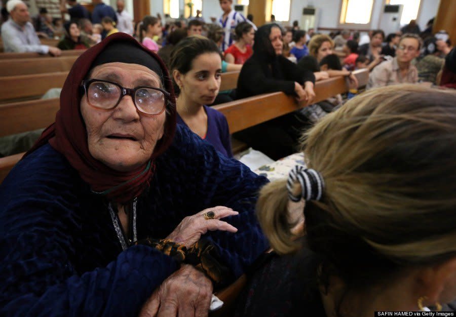 Iraqi Christians who fled the violence in the village of Qaraqush rest upon their arrival at the Saint-Joseph church in Arbil on August 7, 2014. (SAFIN HAMED/AFP/Getty Images) 