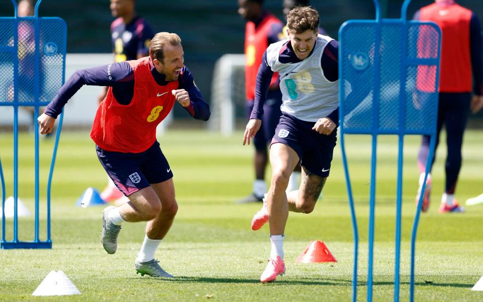 Harry Kane with John Stones race during training