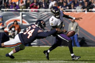 Chicago Bears outside linebacker Robert Quinn (94) strips the ball from Baltimore Ravens quarterback Tyler Huntley during the first half of an NFL football game Sunday, Nov. 21, 2021, in Chicago. (AP Photo/David Banks)