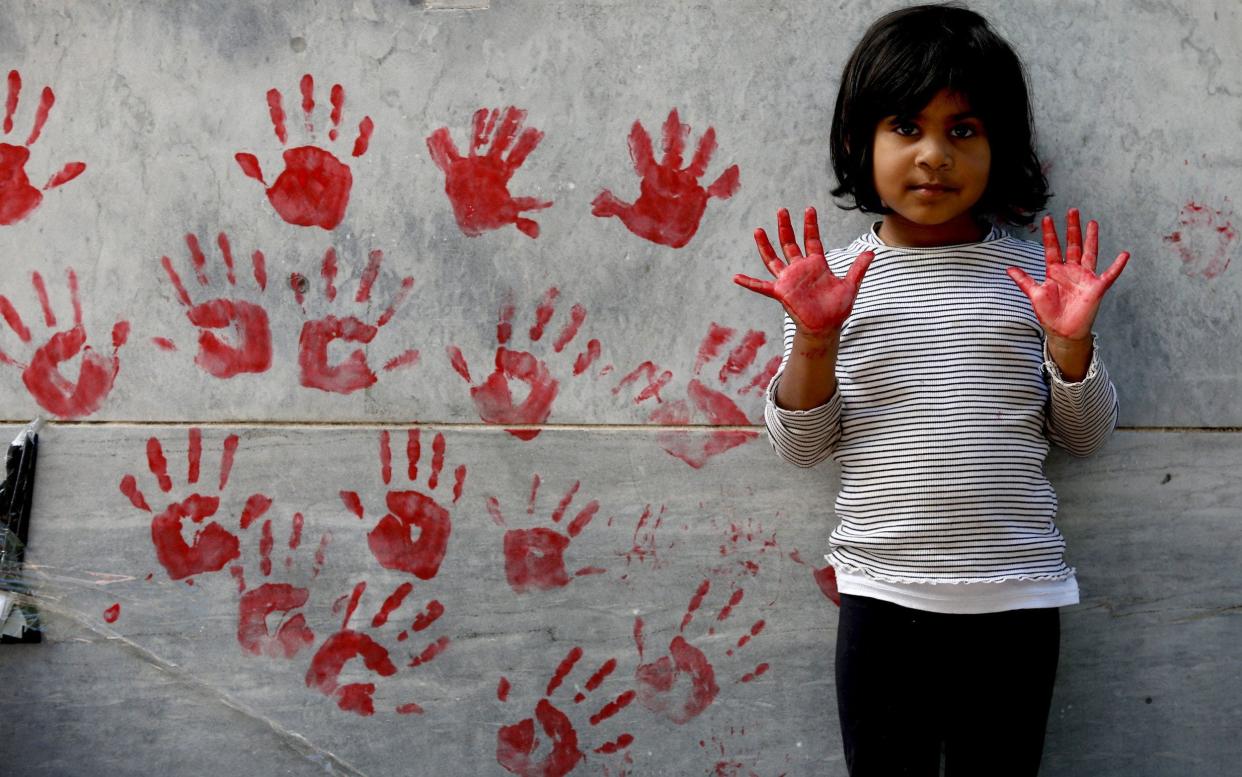 Protestors leave red paint hand prints on a pillar during a protest outside the South Australian Parliament in Adelaide - REX