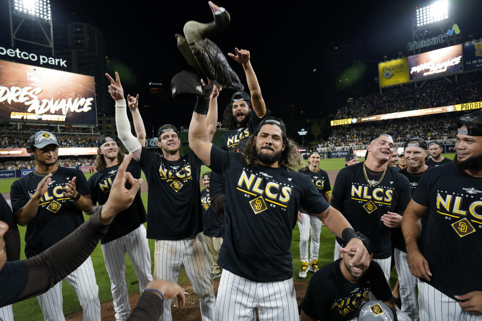 San Diego Padres pitcher Sean Manaea holds a goose decoy as he celebrates with teammates after the Padres defeated the Los Angeles Dodgers 5-3 in Game 4 of a baseball NL Division Series, Saturday, Oct. 15, 2022, in San Diego. (AP Photo/Ashley Landis)