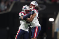 New England Patriots linebacker Jahlani Tavai (48) and New England Patriots safety Adrian Phillips (21) celebrate a defense of stop of the Atlanta Falcons during the second half of an NFL football game, Thursday, Nov. 18, 2021, in Atlanta. (AP Photo/Brynn Anderson)