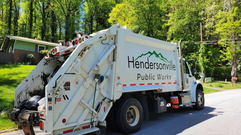 Workers with Hendersonville Public Works collect trash on April 25 in Hendersonville.