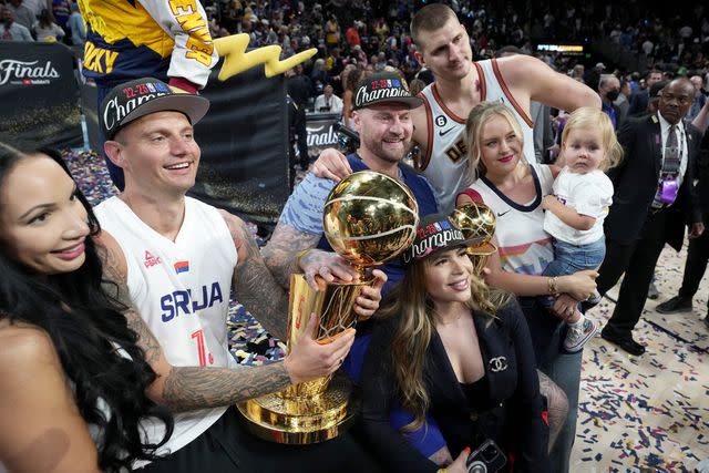 <p>Jesse D. Garrabrant/NBAE via Getty</p> Nikola Jokic and his family